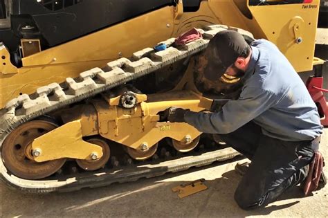 track adjustment on a mustang skid steer|how to adjust track tension.